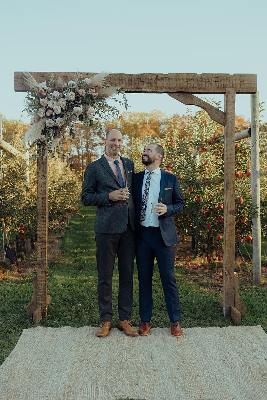 The wooden ceremony arch Dave built by hand, standing on the ceremony lawn at South Road Farm